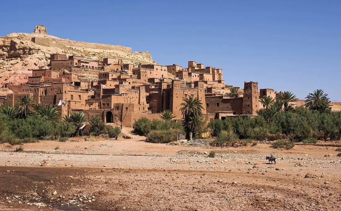 The earthen kasbah of Aït Benhaddou glowing at sunset